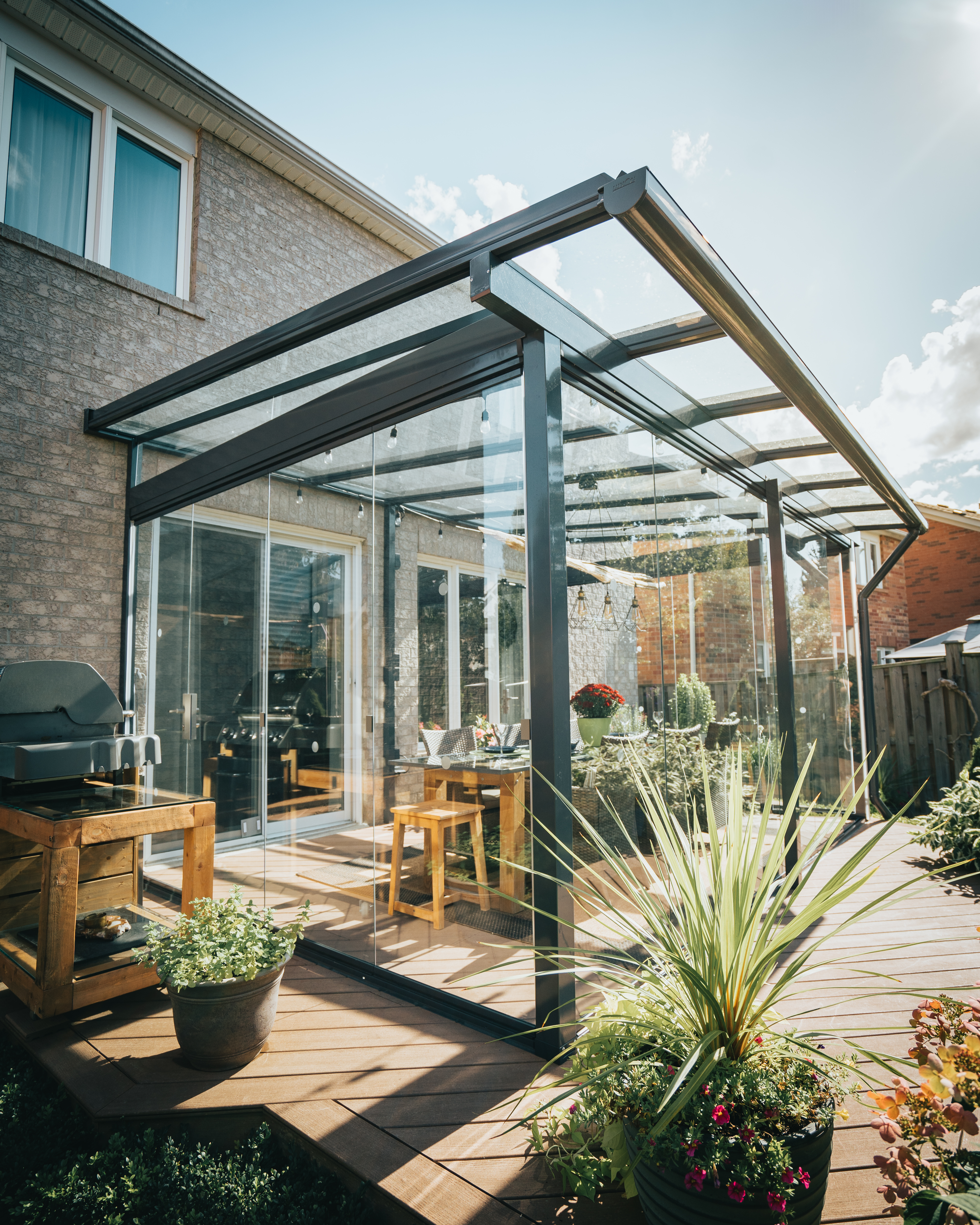 Lumon frameless glass walls enclosing a covered patio